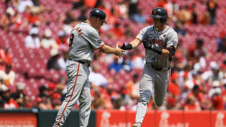 San Francisco Giants shortstop Tyler Fitzgerald (49) shakes hands with third base coach Matt Williams (9) after hitting a two-run home run in the eighth inning against the Cincinnati Reds at Great American Ball Park on Aug 4.