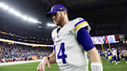 Jan 13, 2025; Glendale, AZ, USA; Minnesota Vikings quarterback Sam Darnold (14) reacts as he walks off the field after losing to the Los Angeles Rams during an NFC wild card game at State Farm Stadium.