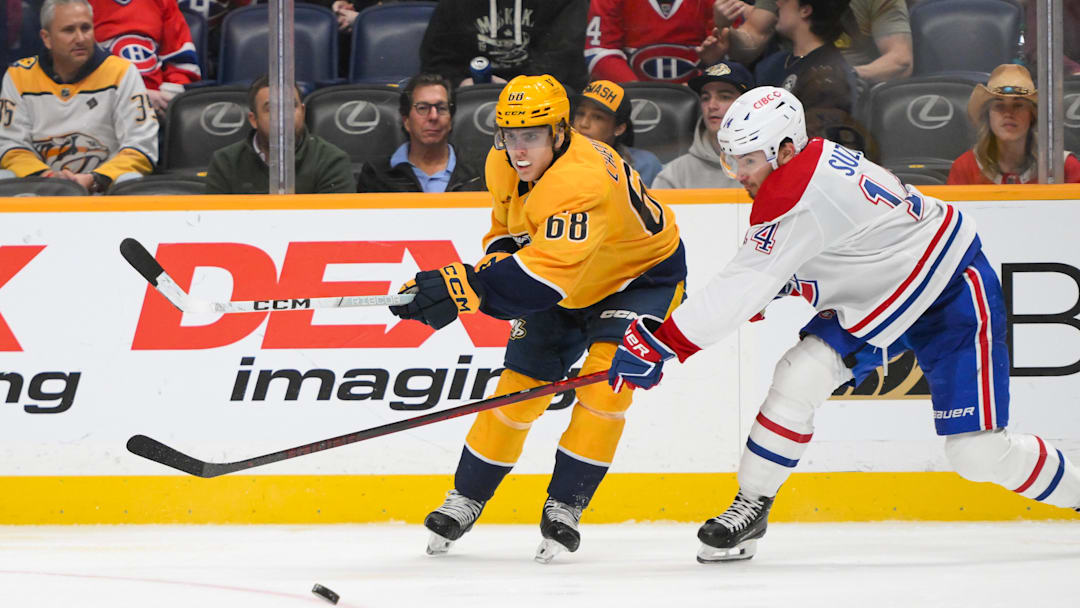 Apr 6, 2025; Nashville, Tennessee, USA;  Nashville Predators left wing Zachary L'Heureux (68) blocks the shot of Montreal Canadiens center Nick Suzuki (14) during the third period at Bridgestone Arena. Mandatory Credit: Steve Roberts-Imagn Images