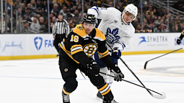 Feb 25, 2025; Boston, Massachusetts, USA; Boston Bruins center John Beecher (19) and Toronto Maple Leafs center Max Domi (11) battle for the puck during the second period at the TD Garden. Mandatory Credit: Brian Fluharty-Imagn Images