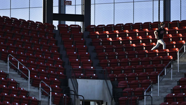 May 16, 2023; St. Louis, Missouri, USA;  A fan runs through an empty sections of seats before a game between the St. Louis Cardinals and the Milwaukee Brewers at Busch Stadium. Mandatory Credit: Jeff Curry-USA TODAY Sports