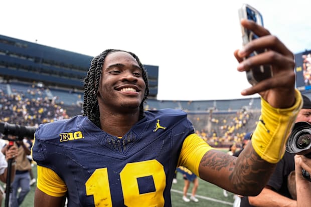 Michigan quarterback Bryce Underwood records a video to celebrate a 63-3 win over Central Michigan.
