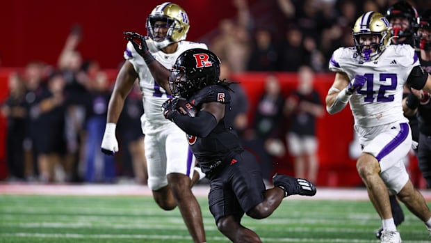 Rutgers Scarlet Knights running back Kyle Monangai (5) carries the ball as Washington Huskies pursue