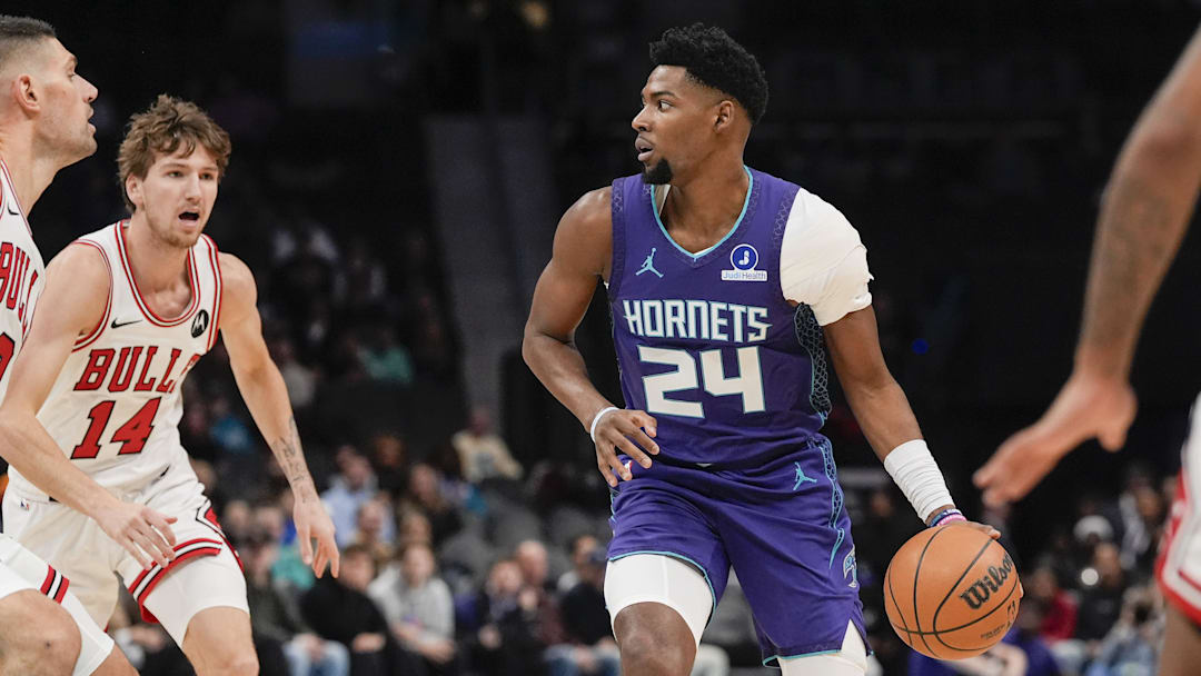 Dec 12, 2025; Charlotte, North Carolina, USA; Charlotte Hornets forward Brandon Miller (24) handles the ball against Chicago Bulls forward Matas Buzelis (14) during the first quarter at Spectrum Center. Mandatory Credit: Jim Dedmon-Imagn Images