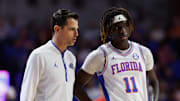 Jan 25, 2025; Gainesville, Florida, USA; Florida Gators head coach Todd Golden talks with Florida Gators guard Denzel Aberdeen (11) during a timeout against the Georgia Bulldogs during the second half at Exactech Arena at the Stephen C. O'Connell Center. Mandatory Credit: Matt Pendleton-Imagn Images