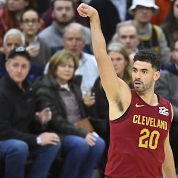 Jan 30, 2025; Cleveland, Ohio, USA; Cleveland Cavaliers forward Georges Niang (20) follows through on a three-point basket in the third quarter against the Atlanta Hawks at Rocket Mortgage FieldHouse. Mandatory Credit: David Richard-Imagn Images