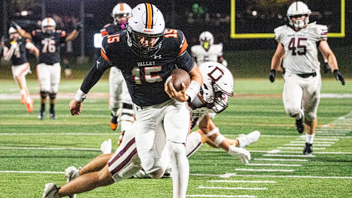 Valley quarterback Drake DeGroote (15) lunges forward for a touchdown during a high school football game between Valley and Dowling Catholic on Aug. 29, 2025, at Valley Stadium in West Des Moines, Iowa. Valley defeated Dowling Catholic 20-19.