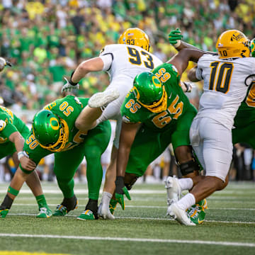 Oregon linemen hold the line during a point after kick as the Oregon Ducks host the Idaho Vandals Saturday, Aug. 31, 2024 at Autzen Stadium in Eugene, Ore.