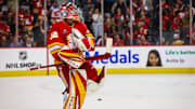 Apr 15, 2025; Calgary, Alberta, CAN; Calgary Flames goaltender Dustin Wolf (32) celebrates win after defeating Vegas Golden Knights at Scotiabank Saddledome. Mandatory Credit: Sergei Belski-Imagn Images