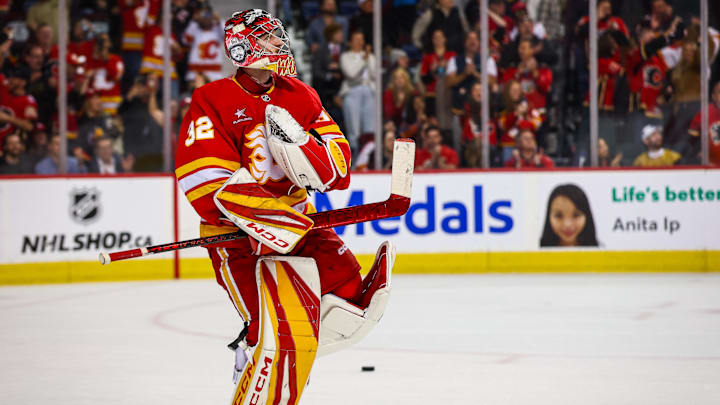 Apr 15, 2025; Calgary, Alberta, CAN; Calgary Flames goaltender Dustin Wolf (32) celebrates win after defeating Vegas Golden Knights at Scotiabank Saddledome. Mandatory Credit: Sergei Belski-Imagn Images
