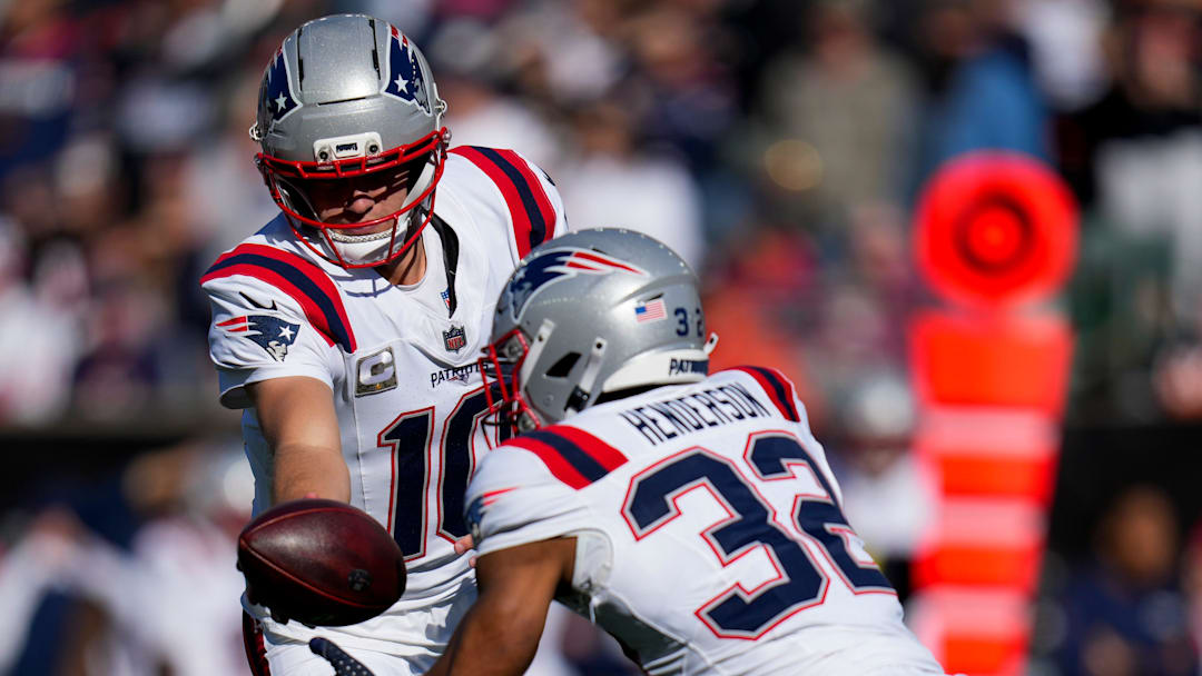 New England Patriots quarterback Drake Maye (10) hands off to running back TreVeyon Henderson (32) in the first quarter of the NFL Week 12 game between the Cincinnati Bengals and the New England Patriots at Paycor Stadium in downtown Cincinnati on Sunday, Nov. 23, 2025.