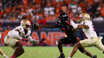 Oct 26, 2024; Miami Gardens, Florida, USA; Miami Hurricanes wide receiver Isaiah Horton (2) attempts but cannot catch the football against Florida State Seminoles defensive back Azareye'h Thomas (8) and linebacker Omar Graham Jr. (9) during the fourth quarter at Hard Rock Stadium. Mandatory Credit: Sam Navarro-Imagn Images