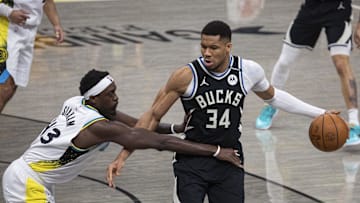 Apr 19, 2025; Indianapolis, Indiana, USA;  Milwaukee Bucks forward Giannis Antetokounmpo (34) dribbles the ball while Indiana Pacers forward Pascal Siakam (43) defends in the first half at Gainbridge Fieldhouse. Mandatory Credit: Trevor Ruszkowski-Imagn Images