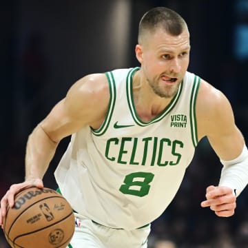 Mar 5, 2024; Cleveland, Ohio, USA;  Boston Celtics center Kristaps Porzingis (8) brings the ball up court during the first half against the Cleveland Cavaliers at Rocket Mortgage FieldHouse. Mandatory Credit: Ken Blaze-USA TODAY Sports
