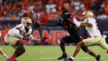 Oct 26, 2024; Miami Gardens, Florida, USA; Miami Hurricanes wide receiver Isaiah Horton (2) attempts but cannot catch the football against Florida State Seminoles defensive back Azareye'h Thomas (8) and linebacker Omar Graham Jr. (9) during the fourth quarter at Hard Rock Stadium. Mandatory Credit: Sam Navarro-Imagn Images