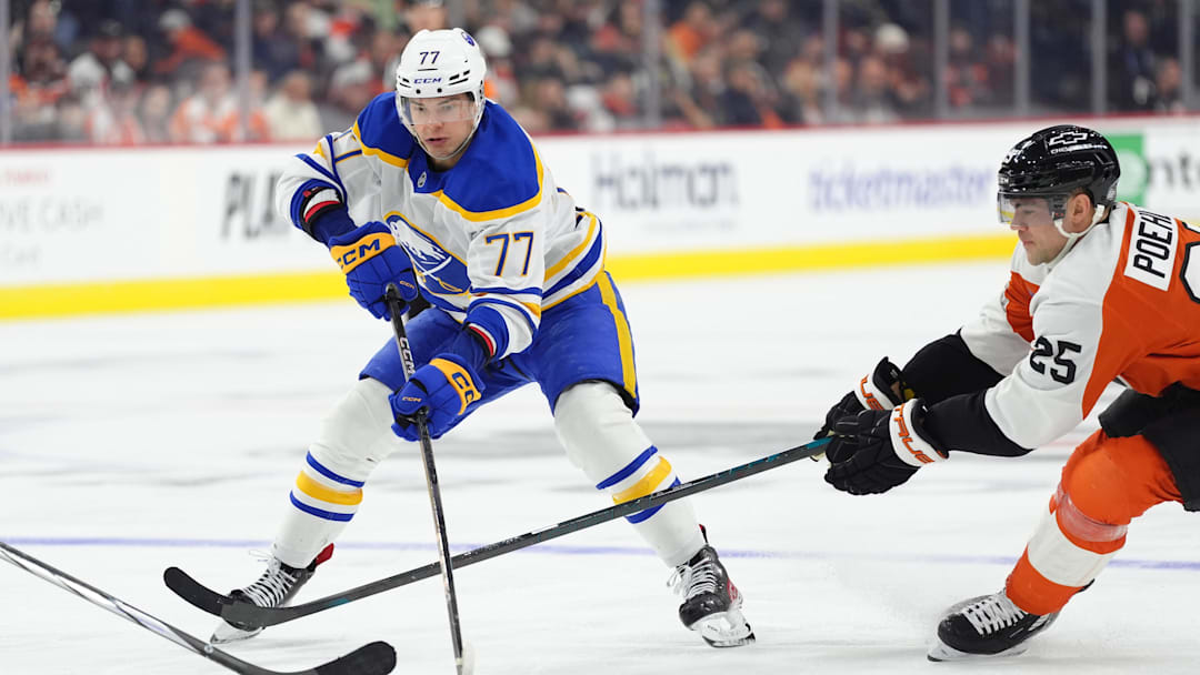Mar 29, 2025; Philadelphia, Pennsylvania, USA; Buffalo Sabres right wing JJ Peterka (77) controls the puck against Philadelphia Flyers center Ryan Poehling (25) in the third period at Wells Fargo Center. Mandatory Credit: Kyle Ross-Imagn Images