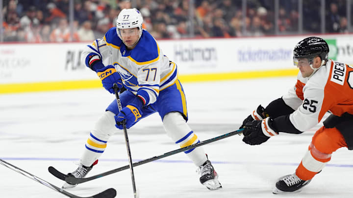 Mar 29, 2025; Philadelphia, Pennsylvania, USA; Buffalo Sabres right wing JJ Peterka (77) controls the puck against Philadelphia Flyers center Ryan Poehling (25) in the third period at Wells Fargo Center. Mandatory Credit: Kyle Ross-Imagn Images