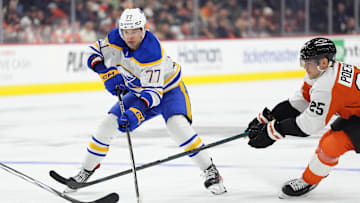 Mar 29, 2025; Philadelphia, Pennsylvania, USA; Buffalo Sabres right wing JJ Peterka (77) controls the puck against Philadelphia Flyers center Ryan Poehling (25) in the third period at Wells Fargo Center. Mandatory Credit: Kyle Ross-Imagn Images