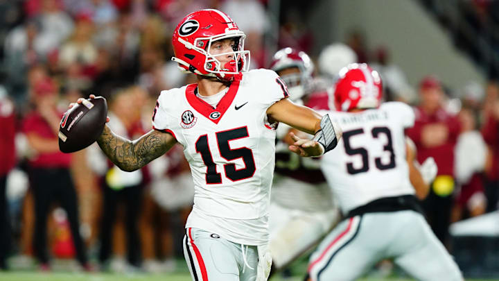 Sep 28, 2024; Tuscaloosa, Alabama, USA;  Georgia Bulldogs quarterback Carson Beck (15) rolls out to throw against the Alabama Crimson Tide during the third quarter at Bryant-Denny Stadium. Mandatory Credit: John David Mercer-Imagn Images