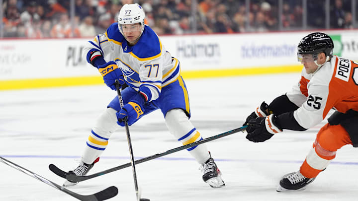 Mar 29, 2025; Philadelphia, Pennsylvania, USA; Buffalo Sabres right wing JJ Peterka (77) controls the puck against Philadelphia Flyers center Ryan Poehling (25) in the third period at Wells Fargo Center. Mandatory Credit: Kyle Ross-Imagn Images