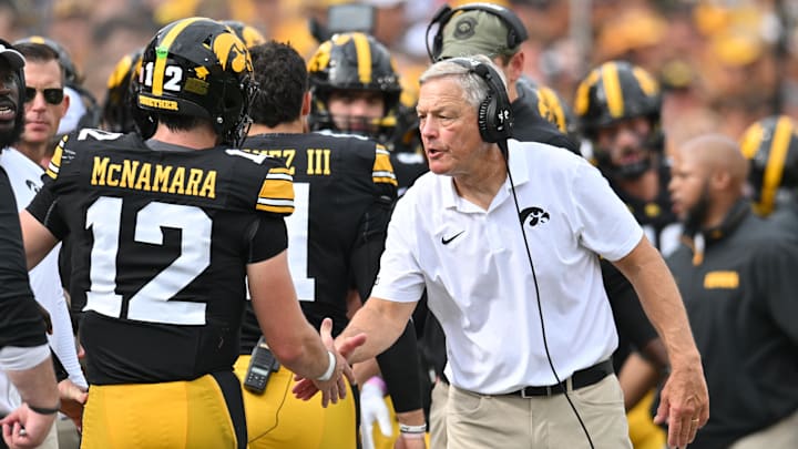 Sep 14, 2024; Iowa City, Iowa, USA; Iowa Hawkeyes head coach Kirk Ferentz reacts with quarterback Cade McNamara (12) after a touchdown against the Troy Trojans during the second quarter at Kinnick Stadium. Mandatory Credit: Jeffrey Becker-Imagn Images