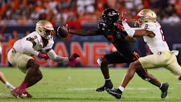 Oct 26, 2024; Miami Gardens, Florida, USA; Miami Hurricanes wide receiver Isaiah Horton (2) attempts but cannot catch the football against Florida State Seminoles defensive back Azareye'h Thomas (8) and linebacker Omar Graham Jr. (9) during the fourth quarter at Hard Rock Stadium. Mandatory Credit: Sam Navarro-Imagn Images
