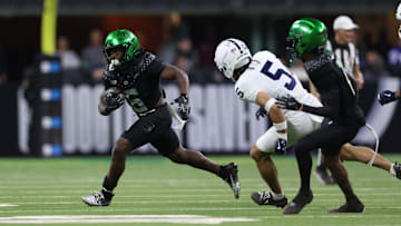 Dec 7, 2024; Indianapolis, IN, USA; Oregon Ducks running back Noah Whittington (6) runs for a gain against the Penn State Nittany Lions during the fourth quarter in the 2024 Big Ten Championship.