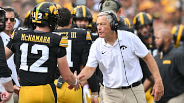 Sep 14, 2024; Iowa City, Iowa, USA; Iowa Hawkeyes head coach Kirk Ferentz reacts with quarterback Cade McNamara (12) after a touchdown against the Troy Trojans during the second quarter at Kinnick Stadium. Mandatory Credit: Jeffrey Becker-Imagn Images