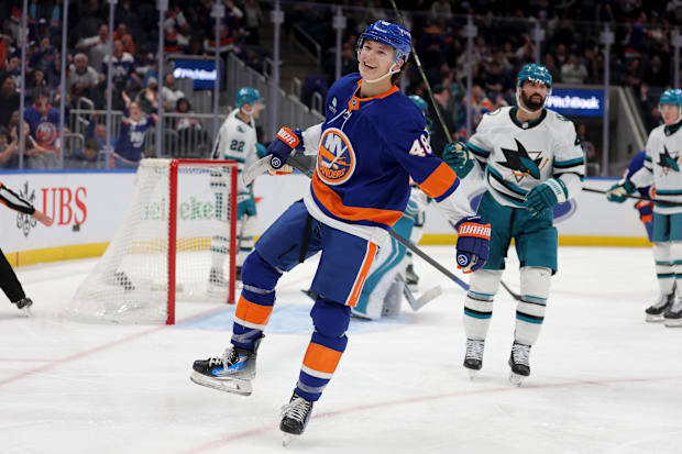 Hockey player in blue uniform celebrates a goal