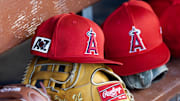 Feb 28, 2025; Phoenix, Arizona, USA; Detailed view of the Los Angeles Angels logo on a hat in the dugout during a spring training game at Camelback Ranch-Glendale. Mandatory Credit: Mark J. Rebilas-Imagn Images