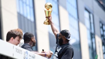Jun 21, 2024; Boston, MA, USA;  Boston Celtics player Jaylen Brown holds the MVP trophy during the Boston Celtics Championship parade. Mandatory Credit: Bob DeChiara-USA TODAY Sports