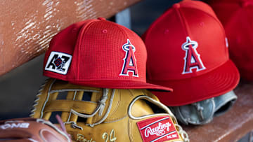 Feb 28, 2025; Phoenix, Arizona, USA; Detailed view of the Los Angeles Angels logo on a hat in the dugout during a spring training game at Camelback Ranch-Glendale. Mandatory Credit: Mark J. Rebilas-Imagn Images