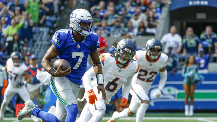 Sep 8, 2024; Seattle, Washington, USA; Seattle Seahawks quarterback Geno Smith (7) rushes for a touchdown against the Denver Broncos during the second quarter at Lumen Field. Mandatory Credit: Joe Nicholson-Imagn Images