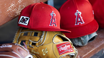 Feb 28, 2025; Phoenix, Arizona, USA; Detailed view of the Los Angeles Angels logo on a hat in the dugout during a spring training game at Camelback Ranch-Glendale. Mandatory Credit: Mark J. Rebilas-Imagn Images