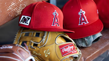 Feb 28, 2025; Phoenix, Arizona, USA; Detailed view of the Los Angeles Angels logo on a hat in the dugout during a spring training game at Camelback Ranch-Glendale. Mandatory Credit: Mark J. Rebilas-Imagn Images