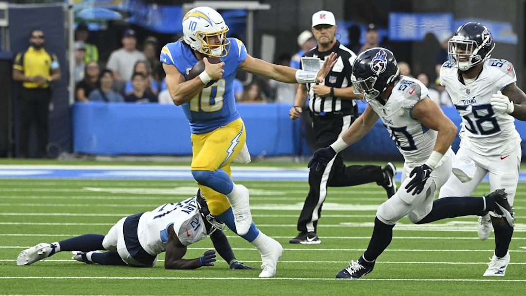 Los Angeles Chargers quarterback Justin Herbert runs with the ball against the Tennessee Titans.