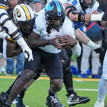 Sep 7, 2024; Columbia, Missouri, USA; Buffalo Bulls quarterback C.J. Ogbonna (7) is sacked by Missouri Tigers defensive end Johnny Walker Jr. (15) during the first half at Faurot Field at Memorial Stadium. Mandatory Credit: Denny Medley-Imagn Images