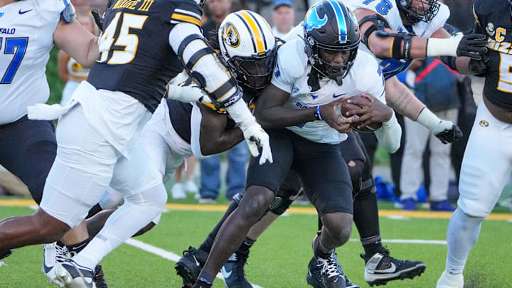 Sep 7, 2024; Columbia, Missouri, USA; Buffalo Bulls quarterback C.J. Ogbonna (7) is sacked by Missouri Tigers defensive end Johnny Walker Jr. (15) during the first half at Faurot Field at Memorial Stadium. Mandatory Credit: Denny Medley-Imagn Images