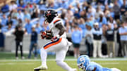 Oct 25, 2025; Chapel Hill, North Carolina, USA; Virginia Cavaliers running back J'Mari Taylor (3) with the ball as North Carolina Tar Heels linebacker Khmori House (7) defends in the fourth quarter at Kenan Stadium. Mandatory Credit: Bob Donnan-Imagn Images