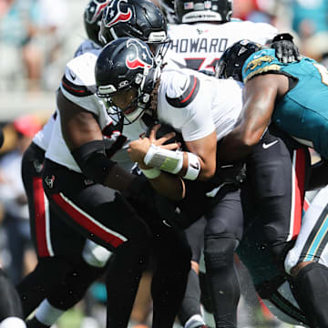Sep 21, 2025; Jacksonville, Florida, USA; Houston Texans quarterback C.J. Stroud (7) gets sacked by Jacksonville Jaguars defensive end Josh Hines-Allen (41) in the third quarter at EverBank Stadium. Mandatory Credit: Morgan Tencza-Imagn Images