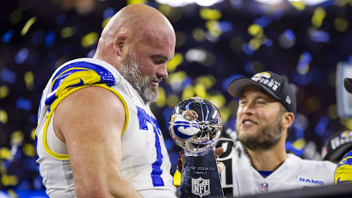 Los Angeles Rams offensive tackle Andrew Whitworth celebrates with the Lombardi Trophy and quarterback Matthew Stafford.