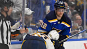 Mar 23, 2025; St. Louis, Missouri, USA;  St. Louis Blues center Radek Faksa (12) grabs Nashville Predators left wing Zachary L'Heureux (68) during the third period at Enterprise Center. Mandatory Credit: Jeff Curry-Imagn Images