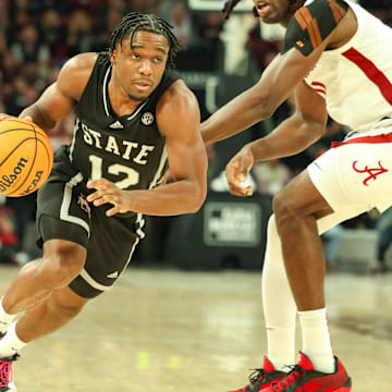 Jan 29, 2025; Starkville, Mississippi, USA; Mississippi State Bulldogs guard Josh Hubbard (12) drives to the basket against the Alabama Crimson Tide during the second half at Humphrey Coliseum. Mandatory Credit: Wesley Hale-Imagn Images