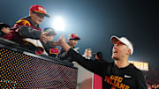 Nov 29, 2025; Los Angeles, California, USA; Southern California Trojans head coach Lincoln Riley celebrates with fans after the game against the UCLA Bruins at United Airlines Field at Los Angeles Memorial Coliseum. Mandatory Credit: Kirby Lee-Imagn Images
