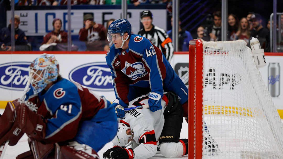 Jan 8, 2026; Denver, Colorado, USA; Colorado Avalanche defenseman Josh Manson (42) and Ottawa Senators left wing Brady Tkachuk (7) battle behind the play in the third period at Ball Arena. Mandatory Credit: Isaiah J. Downing-Imagn Images