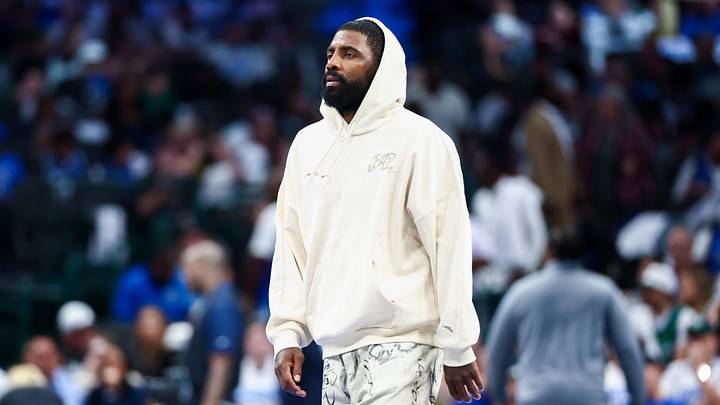 Oct 22, 2025; Dallas, Texas, USA;  Dallas Mavericks injured guard Kyrie Irving walks across the court during the game against the San Antonio Spurs at American Airlines Center. Mandatory Credit: Kevin Jairaj-Imagn Images