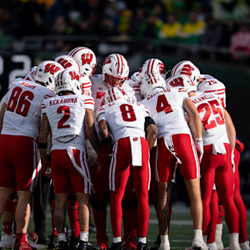 Wisconsin huddles as the Oregon Ducks host the Wisconsin Badgers on Oct. 25, 2025, at Autzen Stadium in Eugene, Oregon.