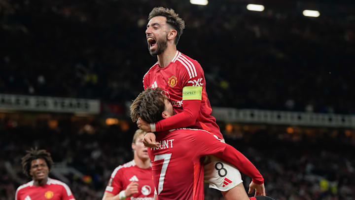Mason Mount holds up Bruno Fernandes as Manchester United celebrate qualification for the Europa League final.