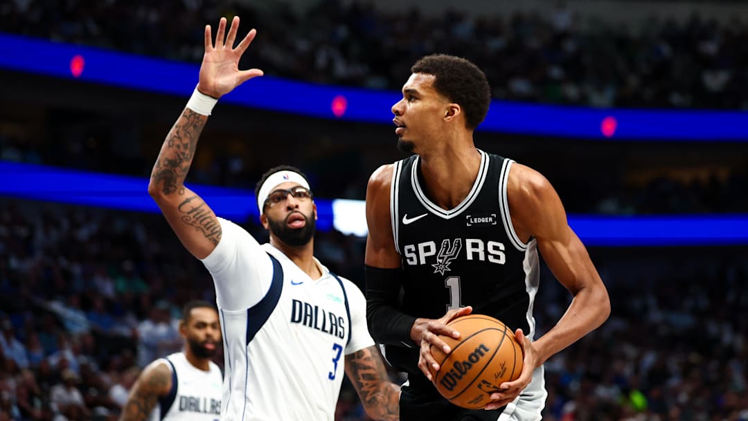 Oct 22, 2025; Dallas, Texas, USA;   San Antonio Spurs forward Victor Wembanyama (1) looks to shoot Dallas Mavericks forward Anthony Davis (3) defends during the second half at American Airlines Center. Mandatory Credit: Kevin Jairaj-Imagn Images