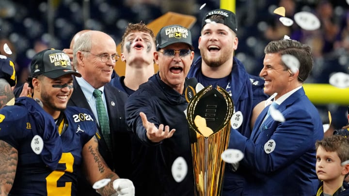 Jan 8, 2024; Houston, TX, USA; Michigan Wolverines head coach Jim Harbaugh celebrates with the CFP Championship trophy after beating the Washington Huskies in the 2024 College Football Playoff national championship game at NRG Stadium. Mandatory Credit: Kirby Lee-USA TODAY Sports